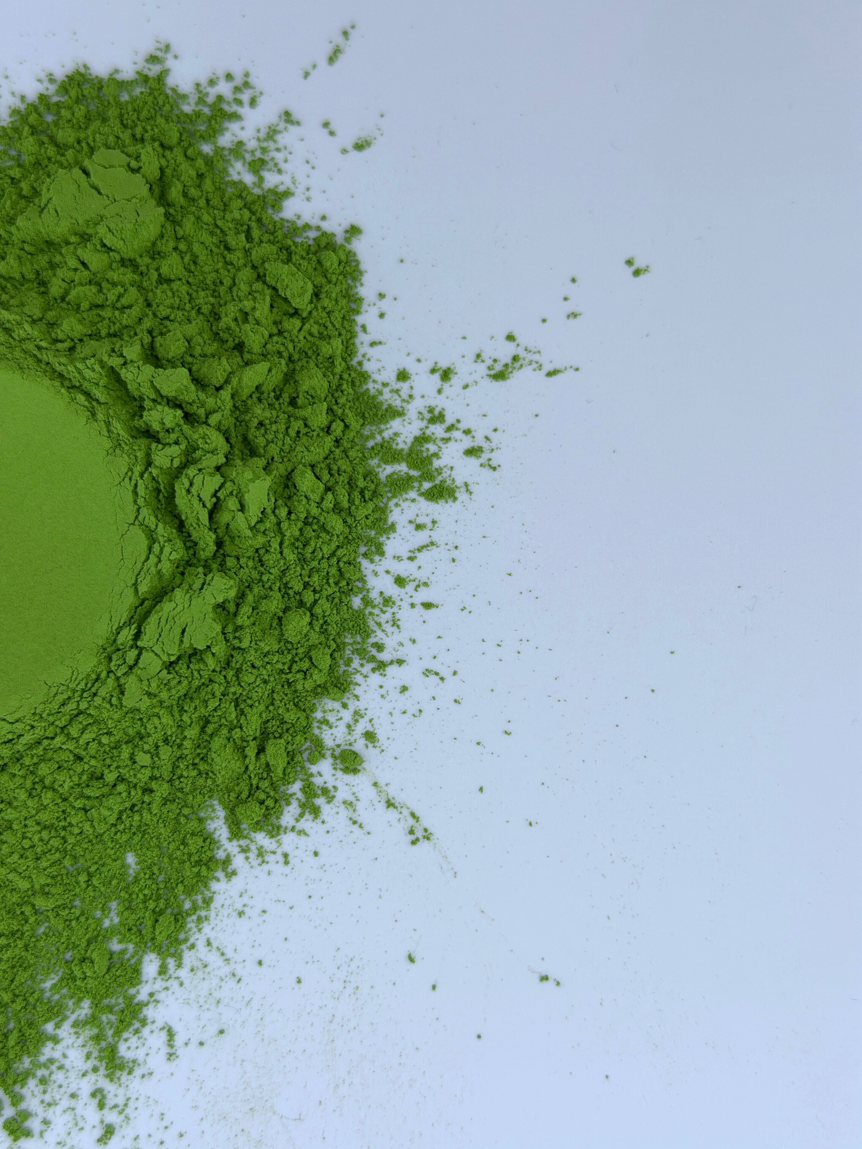 Matcha powder spread in a circle on a white background